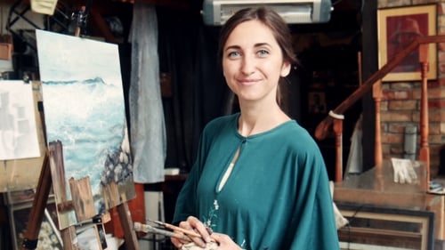 Portrait Of Young Woman Painting a Canvas In a Studio