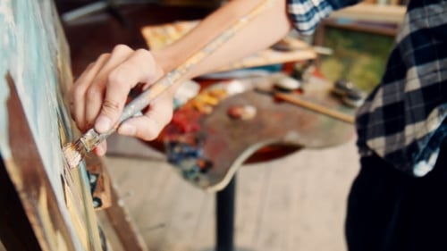 Artist Painting on Canvas in Studio