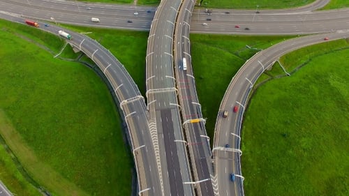 Aerial view of highway surrounded by green fields