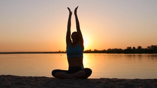 Meditation Near The Sea And Doing Yoga On a Beach At Sunset