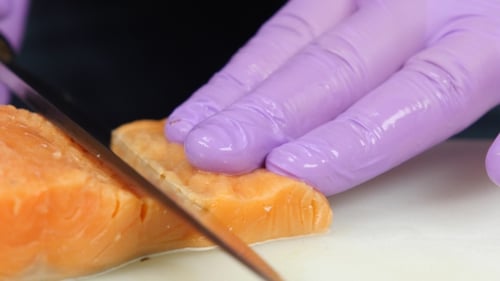 Chef Cuts Slices Of a Red Fish.