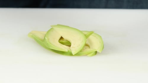Avocado Slicing on a White Cutting Board