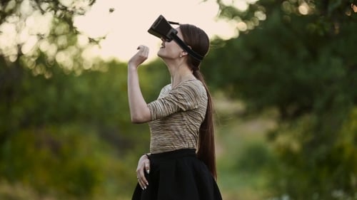 Young Woman Using VR Headset in Nature