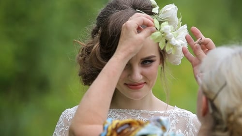 Young Woman Gets Hair Decorated With Flowers Outside