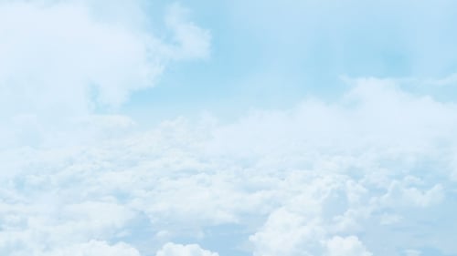 Animated Fluffy Clouds Passing Through a Clear Blue Sky