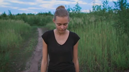Inspired Woman Walking At a Field