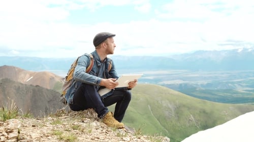 Man Working Outdoors With Tablet Computer