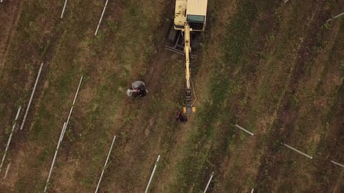Excavator Hammers a Concrete Pillar