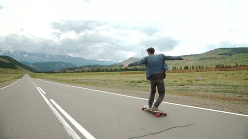 Hipster Man Longboarding Extremely Action In Highway.