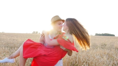 Man Carries Woman in Golden Wheat Field
