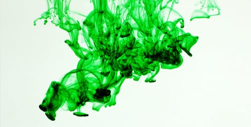 Abstract Green Ink Swirling in Clear Liquid
