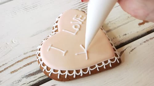 Decorating Heart Shaped Cookie With White Icing