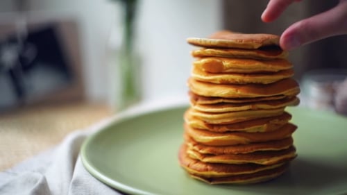 Golden Pancakes Stacked on Green Plate