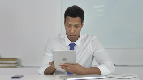 Young Adult Working on Tablet is Surprised