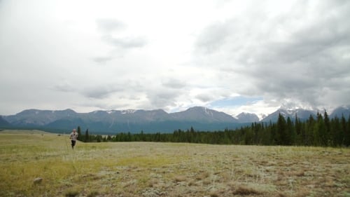 Man Running On a Rural Road During Sunset In The Mountains