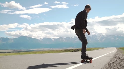 Hipster Man Longboarding Extremely Action in Highway Tropics in Asia