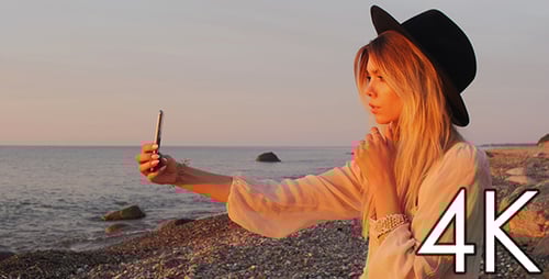 Blonde Woman Posing for Selfie on Rocky Beach