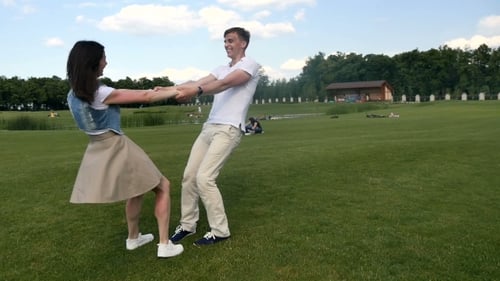 The Guy And Girl Turn Around On The Grass