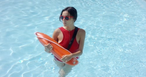 Woman Lifeguard Holding Rescue Buoy in Swimming Pool