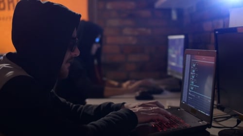 People Working on Computers in Dark Urban Office