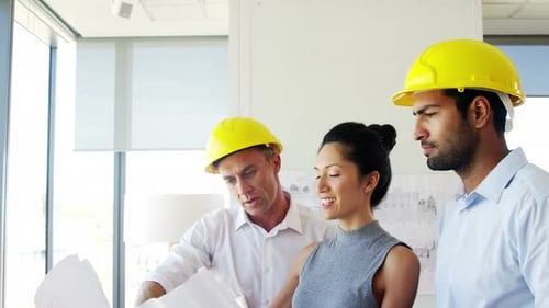 Architects discussing blueprint in a modern office 4k