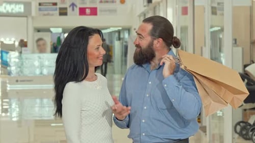 Couple Looks at Purchases in Shopping Mall