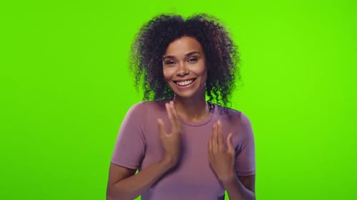 Smiling Woman with Curly Hair Posing on Green Screen
