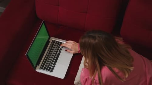 Close Up Businesswoman Lying on Sofa and Working Laptop Green Screen Chromakey at Home