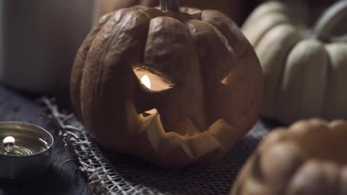 Halloween Carved Pumpkin with Glowing Candle