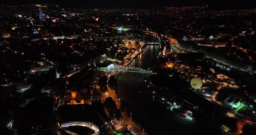 Night aerial view of Bridge of Peace and beautiful cityscape in the center of Tbilisi, Georgia 2022