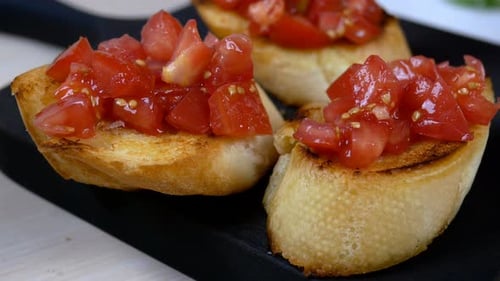 Chef Preparing Classic Italian or Mediterranean Bruschetta with Roasted Baguette