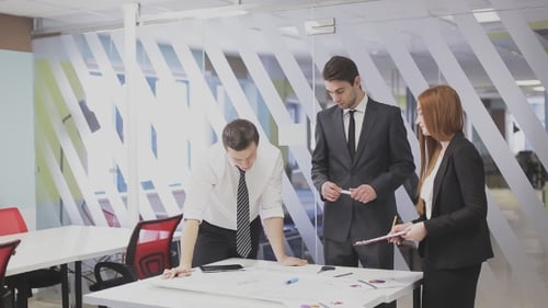 Professionals Collaborating on a Project in Modern Office