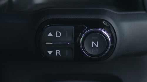 Woman Hand Pushing Reverse Gear Button In Car