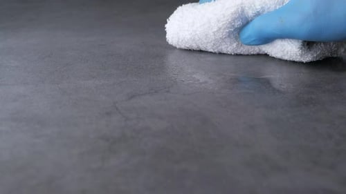 Disinfecting Surface with Glove and White Towel
