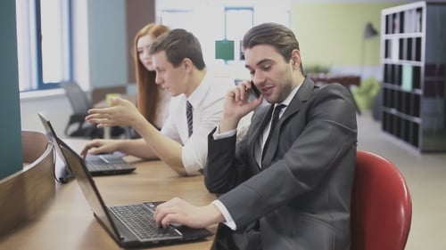 Business Man Talking On The Phone At The Office