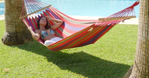 Woman Relaxing in Hammock in Tropical Setting