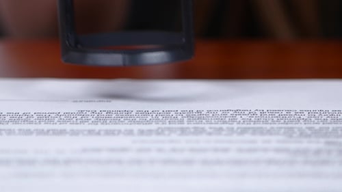 Rubber Stamp Presses "Again" on Paper