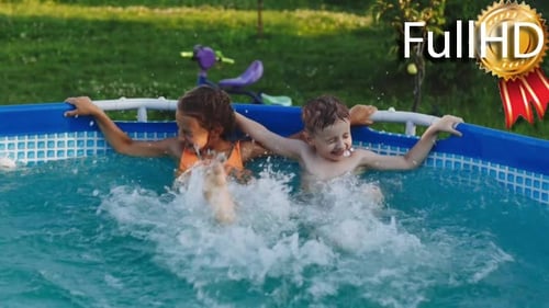 Happy Brother and Sister Splash in the Pool
