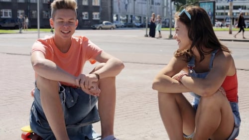 Teenage Couple With Penny Boards Talking In City 13