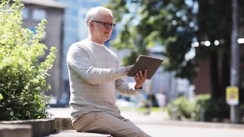 Senior Man With Tablet Pc On City Street