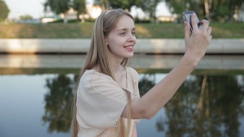 Young Smiling Teen Happy Woman Making Selfie On The Street