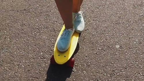 Teenage Girl Feet Riding Short Modern Skateboard