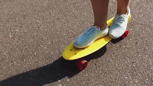 Teenage Girl Feet Riding Short Modern Skateboard