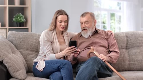 Daughter Granddaughter Teaching to Elderly Father Grandfather Smartphone Chatting Application