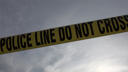 Police Line Crime Scene Tape Against Cloudy Sky