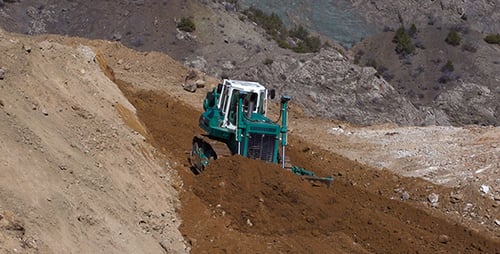 Bulldozer Leveling Hillside in a Mountainous Area