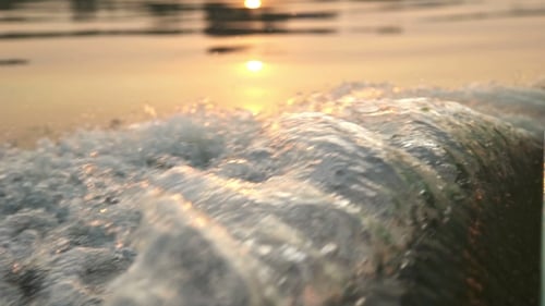 Boat Gliding In Open Sea At Sunset