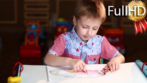Boy Paints the Car With Crayons Sitting at Table