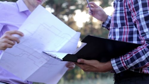 Two Structural Engineer Planning The Construction Of a Monolithic Buildings