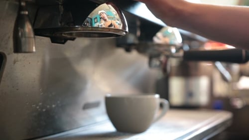 Young Barista Preparing Coffee In a Cafe